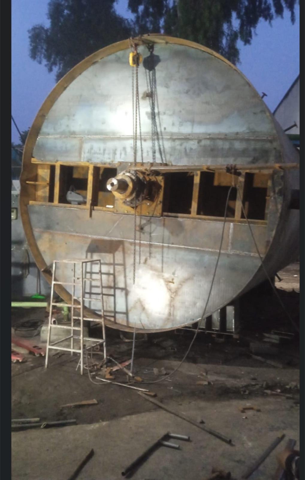 Large cylindrical steel tank with a central shaft assembly during fabrication